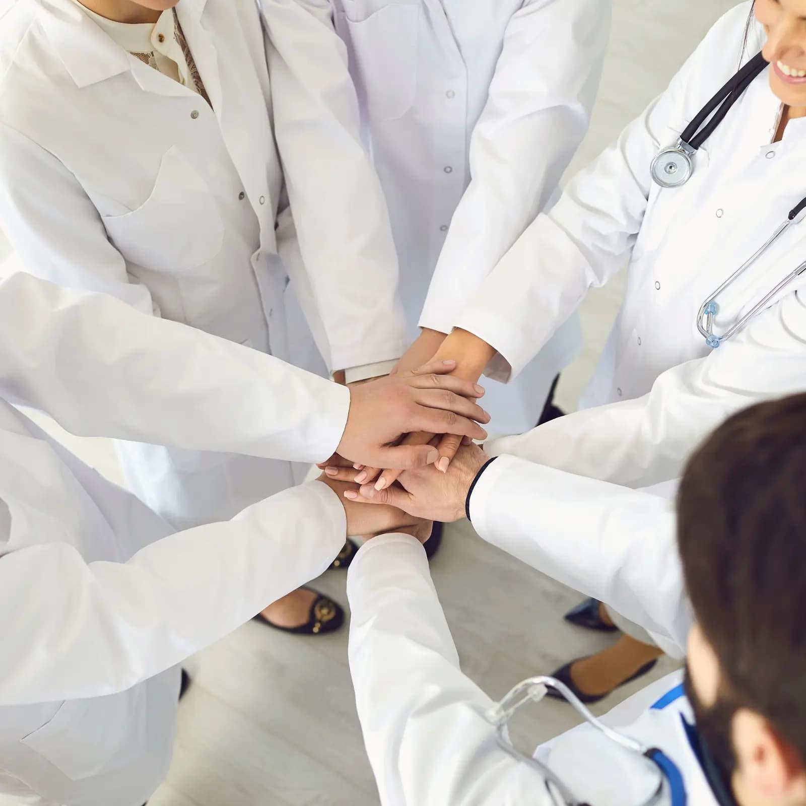 The Avangard-Med team of doctors joining hands